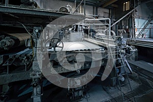 Production machine with rolls of new paper in waste paper recycling factory