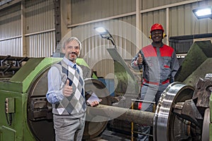 Production Manager And African American CNC Machine Operator Giving Thumbs Up In A Train Factory