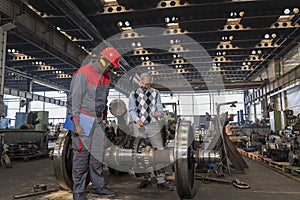 Production Manager Talking To African American Worker In Protective Workwear At Train Factory