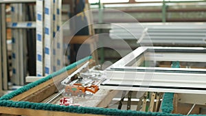 Production and manufacturing of plastic windows pvc, on the table lies the sash window, screwdriver, the shop is