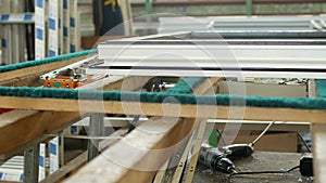 Production and manufacturing of plastic windows pvc, on the table lies the sash window, screwdriver, the shop is