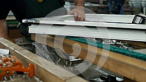 Production and manufacturing of pvc windows, male worker produces pvc window assembly collects sash windows, pvc profile