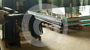 Production and manufacturing of pvc windows, the working specialist glues the glass of the double-glazed window for