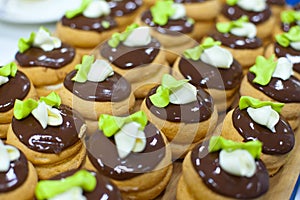 Production of pralines at confectionary factory. Food industral cake line - conveyor belt with sweets