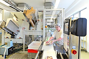 Production of pralines in a factory for the food industry - conveyor belt worker with chocolate photo