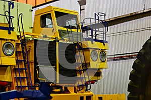 The production process of assembling career heavy mining dump trucks on a conveyor line at the automobile plant Belaz