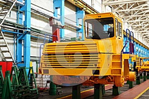 Production process of heavy mining trucks at the factory. Dump truck on the Industrial conveyor in the workshop