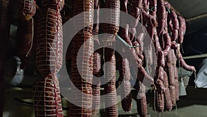 Production of sausages homemade. Italian different traditional salami and bacon smoked arranged in a row. smoked capocollo and