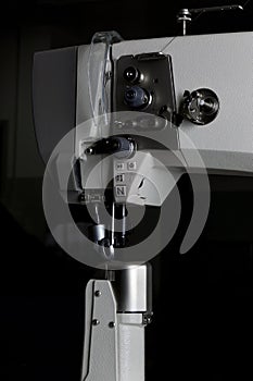 Production sewing machine on a black background close-up. details of a professional sewing machine