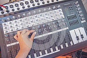 Production sound engineer hands working on recording studio mixing voice control. Expert adjusting volume equalizer voice, mixing