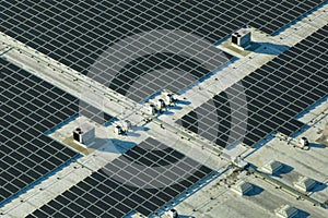 Production of sustainable energy. Aerial view of solar power plant with blue photovoltaic panels mounted on industrial