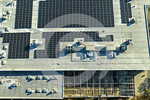 Production of sustainable energy. Aerial view of solar power plant with blue photovoltaic panels mounted on industrial