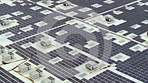 Production of sustainable energy. Aerial view of solar power plant with blue photovoltaic panels mounted on industrial