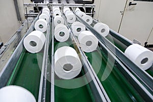 Production of Toilet paper in factory. Toilet paper rolls making machine. Tissue and Kitchen Towels Machine. Long conveyor with to