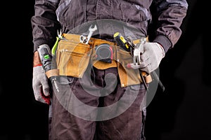 Production worker with tool belt. Worker& x27;s hammer