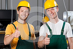 Production workers showing thumbs up sign