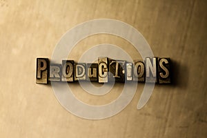 PRODUCTIONS - close-up of grungy vintage typeset word on metal backdrop photo