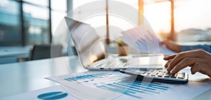 The productive workspace with documents, calculator, and laptop in sunlight. AI generated image