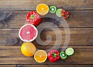 Products containing vitamin C on wooden background. word C made from fruits and vegetables rich in vitamin C