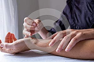 Profesional woman giving acupuncture treatment