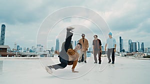 Profession break dancer practice B-boy dance with friends at roof top. hiphop.