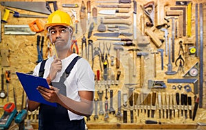 Thinking builder with clipboard and pencil