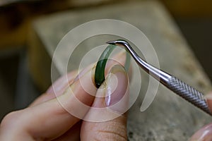 Profession jeweler. Craft jewelery making. Hands of a jeweller . Handwork . Close up.