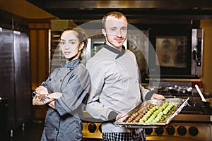 Profession preparation confectionery products. Caucasian man and woman two employees colleague teamwork pastry chef posing looking