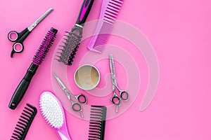 Professional accessories of hairdresser on work desk pink background top view space for text