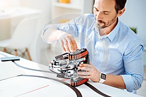 Professional adult engineer working on the robot