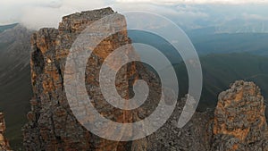 Professional aerial view of a rocky mountain in the evening at sunset. Sharp Cliffs Extreme Climbing Concept