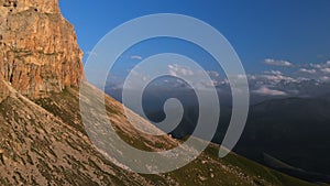 Professional aerial view of a rocky mountain in the evening at sunset. Sharp Cliffs Extreme Climbing Concept