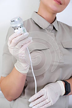 Professional Aesthetician Holding a Facial Machine Handpiece