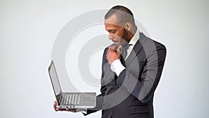 Professional African-American business man holding laptop computer