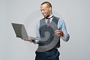 Professional african-american business man holding laptop computer