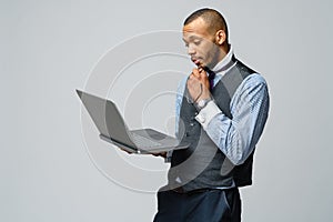 Professional african-american business man holding laptop computer