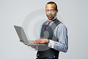 Professional african-american business man holding laptop computer