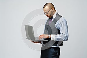 Professional african-american business man holding laptop computer