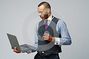 Professional african-american business man holding laptop computer