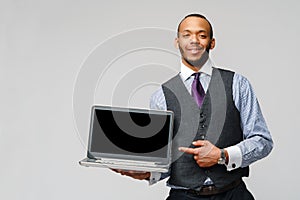 Professional african-american business man holding laptop computer