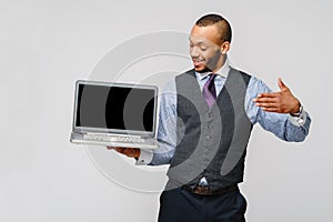 Professional african-american business man holding laptop computer