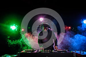 professional african american club DJ in headphones with sound mixer photo