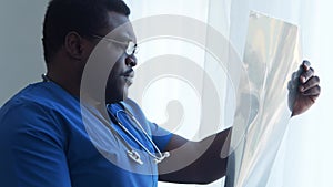 Professional african american medical doctor working in hospital office. Medicine and healthcare.