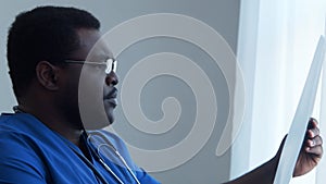 Professional african american medical doctor working in hospital office. Medicine and healthcare.