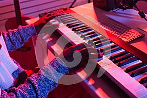 Professional african american musician recording synthesizer in digital studio at home, close-up, Music production