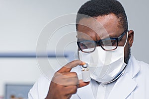 Professional African-American scientist is working on a vaccine in a modern scientific research laboratory. Doctor is