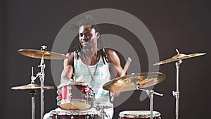 Professional african drummer man playing on drums and cymbals