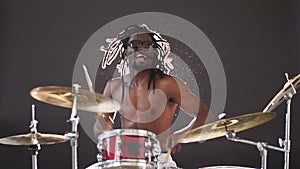 Professional african drummer man playing on drums and cymbals