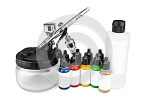 Professional airbrush starter set equipment with chrome metal gun acrylic paint and thinner bottles isolated white background.