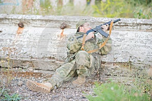 A professional airsoft player aims at his opponents.